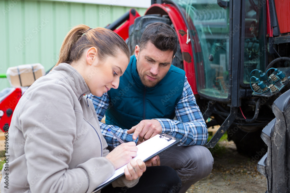 young country woman give to man tractor driver notes