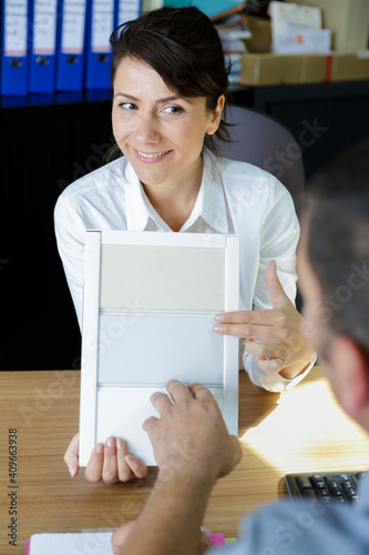 designer showing tiles to customer photo