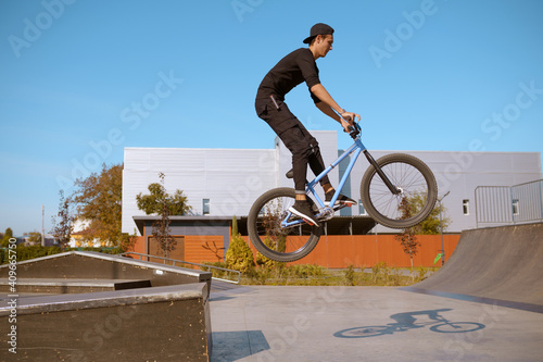 Male bmx biker, jump in action, skatepark