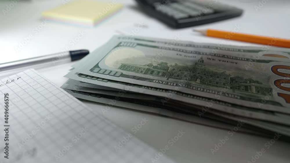 Close-up view of dollars. Woman counts, planning home budget, accountant working in office. Finances, investment, saving money concept. Close-up view of dollars. Woman counts, planning home budget, accountant working in office. Finances, investment, saving money concept.