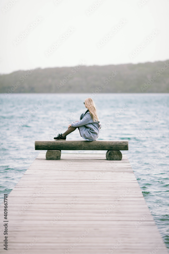 Girl sitting near the sea