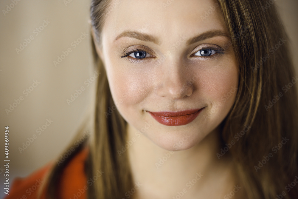 Head shot of a smart confident smiling millennial european woman standing with folded arms at home. Attractive young teenager student girl freelancer looking at camera, dressed in red Head shot of a smart confident smiling millennial european woman standing with folded arms at home. Attractive young teenager student girl freelancer looking at camera, dressed in red