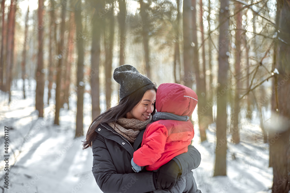 happy family on a walk outdoors in sunny winter forest happy family on a walk outdoors in sunny winter forest