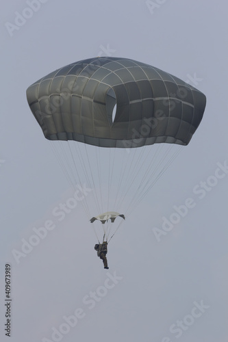 A paratrooper coming down on a parachute