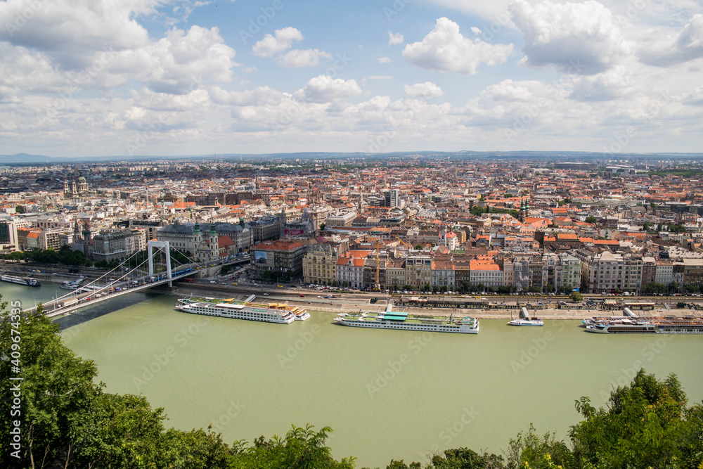 View from Gellert Hill to Budapest. Beautiful architecture of the old and new city. Long bridge over the river Danube. A sunny day in Hungary.