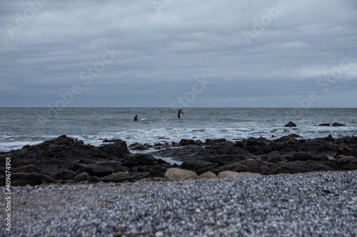 surf y rocas en la orilla en día de tormenta