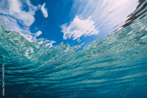 Surface of ocean with sky and sunlight underwater in Hawaii
