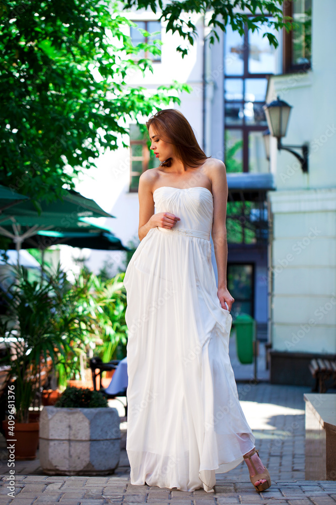 Fototapeta premium Portrait of beautiful model woman in wearing white dress