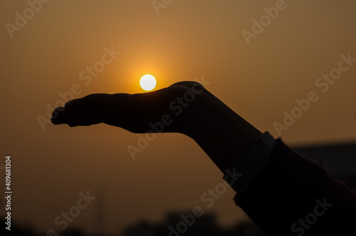 Love story, Crop view of hands catching sun on hands during sunset. Valentines day concept during sunset with golden light.