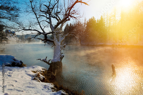 Winter sunrise with a mist on the river with snow, the Dobra River, Croatia photo