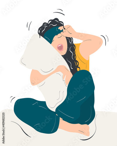 Portrait of a tired young woman wearing sleeping mask and pajamas hugging pillow