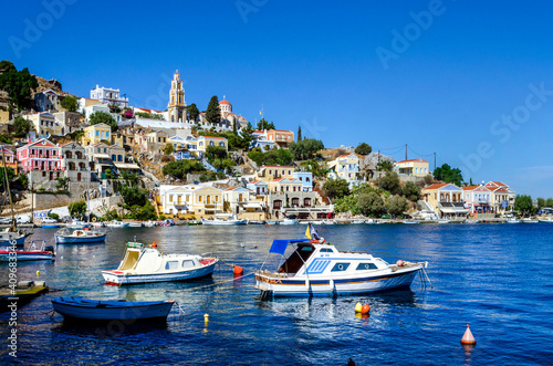 The water front on the Island of Symi with the church of The Annunciation standing on the hill above the fishing boats. .