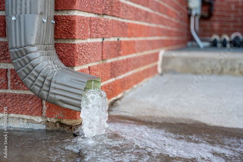 Bilde på lerret Metal downspout jammed with a frozen ice block
