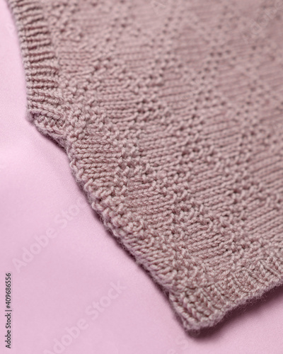 Handmade merino wool vest, super yarn, fashion concept. Close-up, merino wool background.