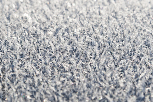 Hoarfrost on a flat surface, closeup, selective focus.