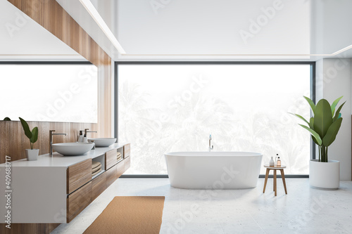 Wooden and white bathroom with white bathtub  sinks and window