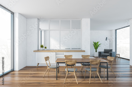 White and wooden living room with chairs and table, armchair and window