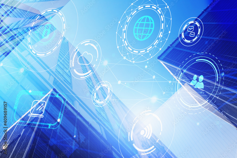 Naklejka premium Technology icons hologram on low, wide angle view of glass and steel contemporary skyscrapers in financial downtown. The concept of success in hi-tech industry. Double exposure.