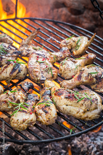 Spicy chicken with rosemary on grill with fire