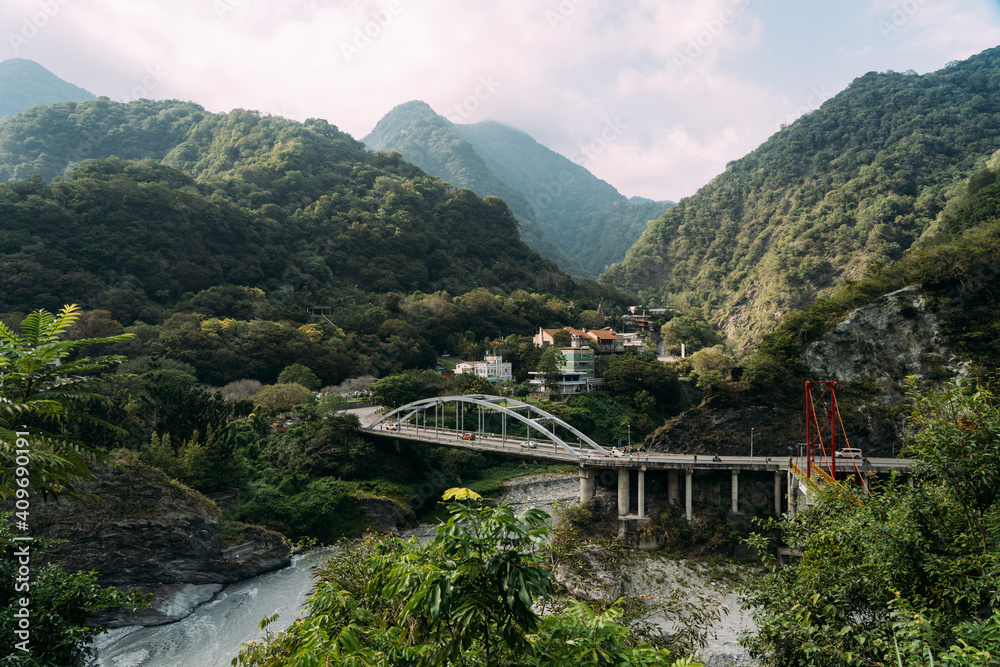 River with bridge, small town and mountains in Taroko National Park, Taiwan.
