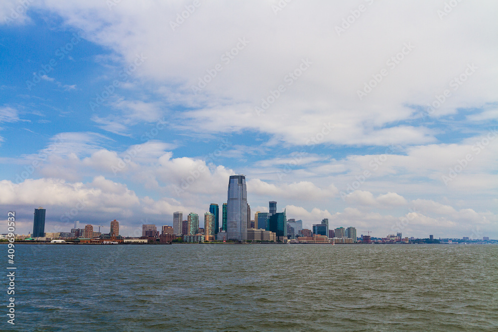 The view of the New York cityscape taken from the ferry on a cloudy day