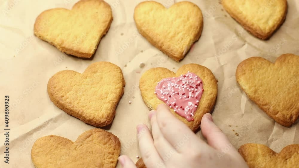 woman decorates cookies with pastry balls, close-up, dessert preparation process woman decorates cookies with pastry balls, close-up, dessert preparation process