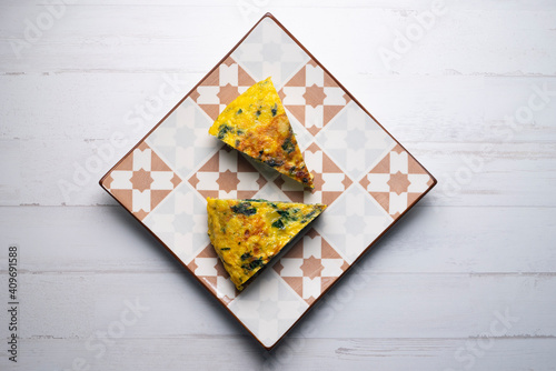 Spanish potato omelette with spinach. Traditional tapa.