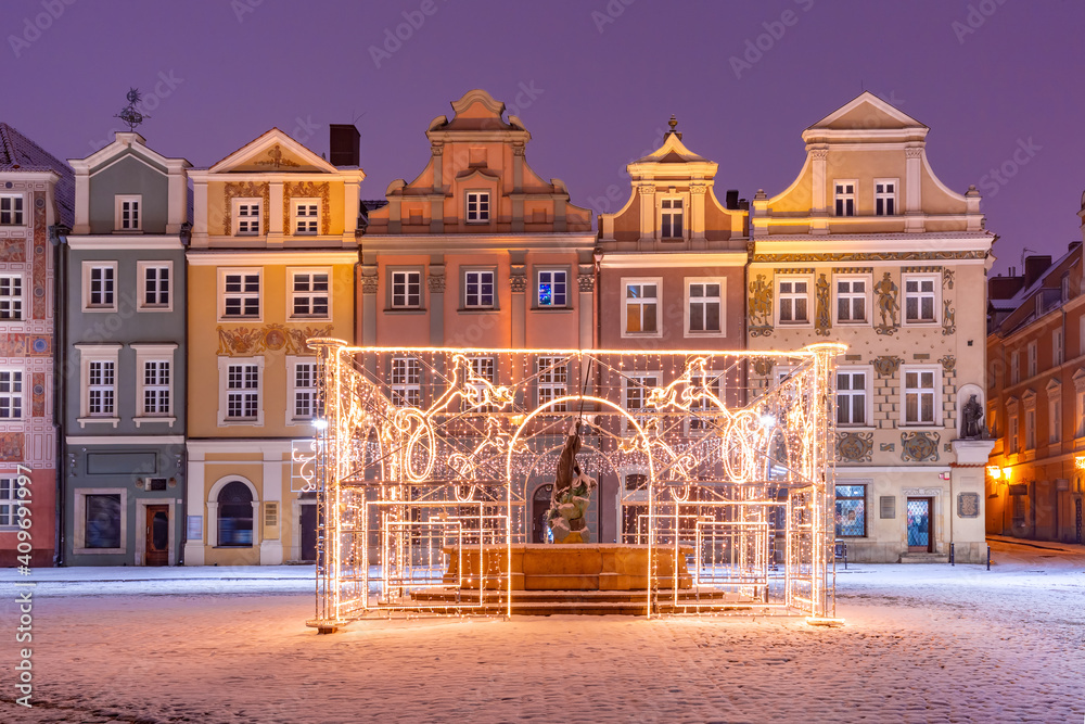 Merchants houses and decorated fountain at Old Market Square in Old Town at Christmas night, Poznan, Poland