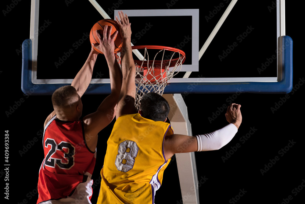 Two basketball players in action. Blocked shot