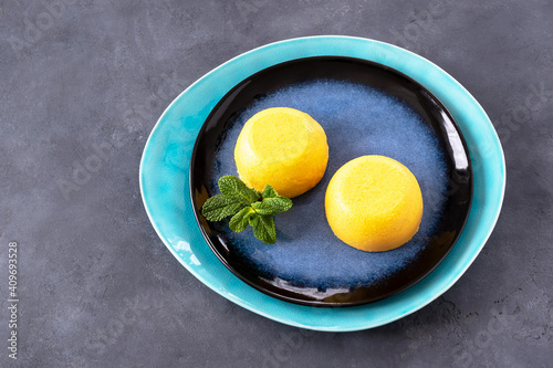 Orange panna cotta with mint. Delicate Italian dessert made from cream with gelatin with the addition of orange.