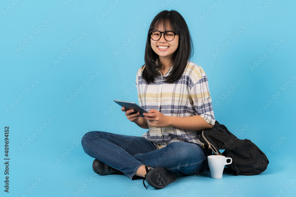 Happy asian student sitting with using tablet Happy asian student sitting with using tablet