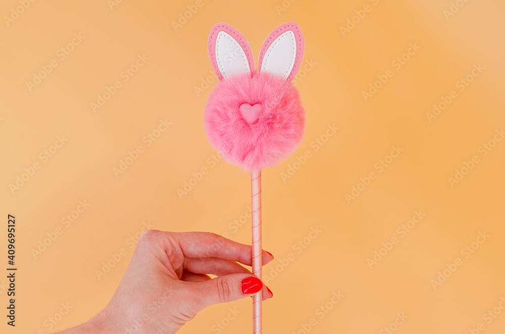 Pink fluffy toy on a stick