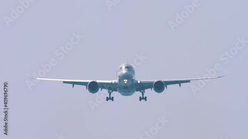 Widebody airplane approaching before landing photo