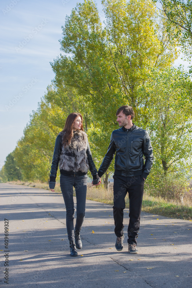 couple of young people are walking on a sunny day. couple of young people are walking on a sunny day.