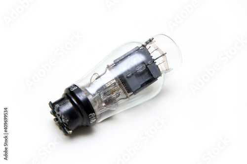 The single vacuum or electron tube isolated on a white background. The obsolete electronic device for current control. 