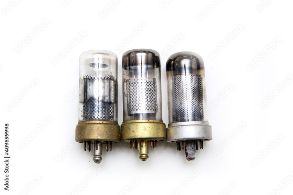 The small group of vacuum or electron tubes isolated on a white background. The obsolete electronic devices for current control. The small group of vacuum or electron tubes isolated on a white background. The obsolete electronic devices for current control.
