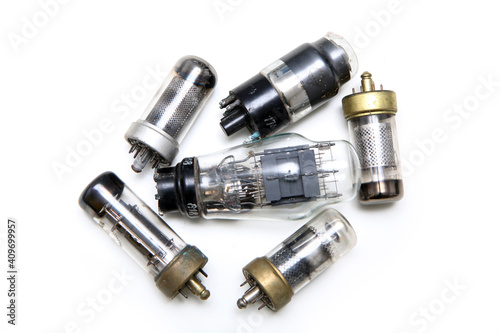 The small group of vacuum or electron tubes isolated on a white background. The obsolete electronic devices for current control. 