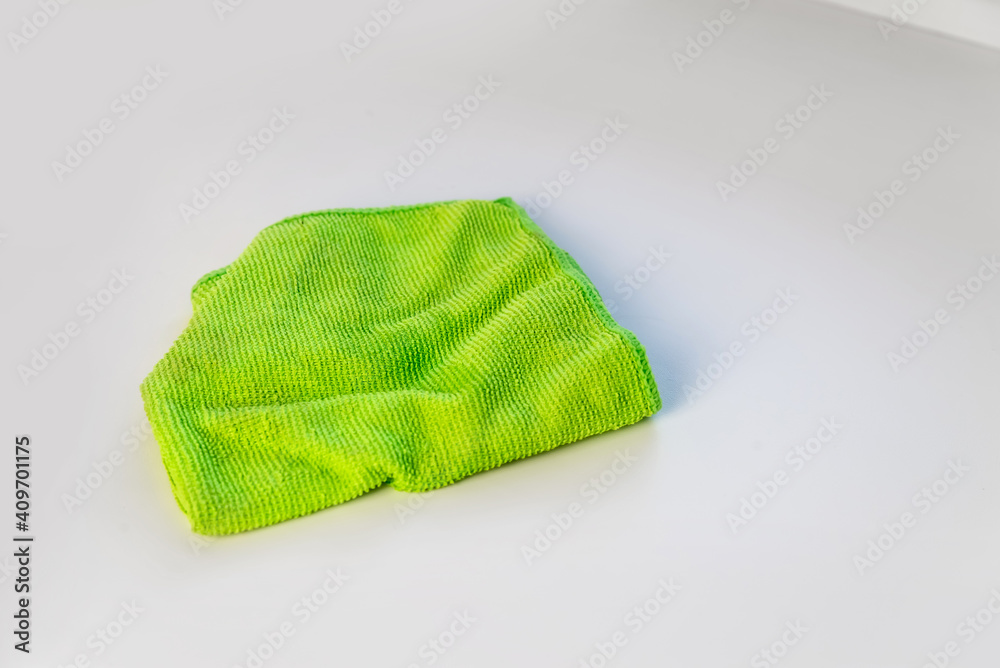 green cloth napkin for cleaning the house and dusting close up on a white background green cloth napkin for cleaning the house and dusting close up on a white background