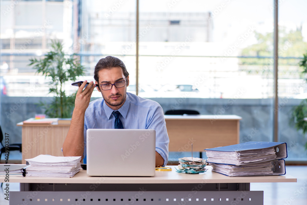 Young male accountant working in the office Young male accountant working in the office