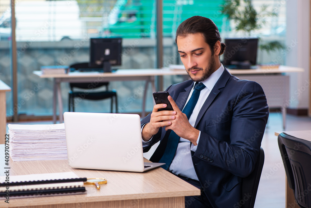 Young male employee working in the office