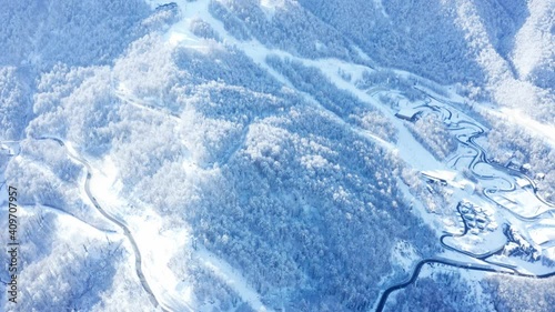 aerial Drone  view of  winter forest and highway  in  mountains