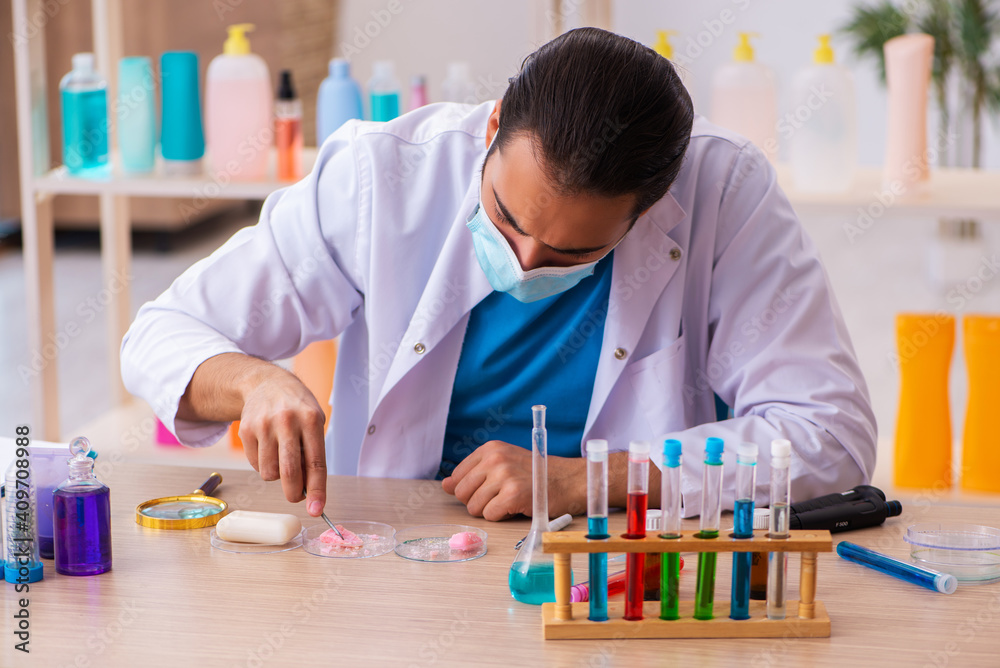 Young male chemist testing soap in the lab Young male chemist testing soap in the lab