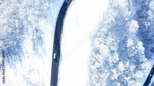 View from a drone to the road with cars in winter.