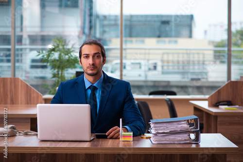 Young male employee working in the office