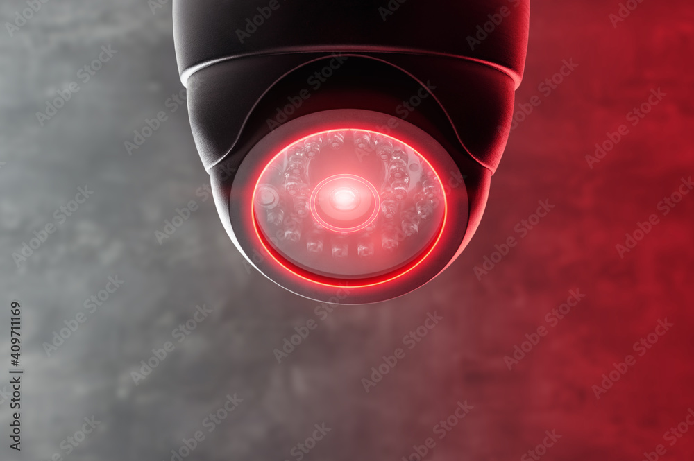 Smart CCTV camera under the ceiling with red lights. Cameras work day and night, video recording in the dark. Protection from thieves and vandals. Smart CCTV camera under the ceiling with red lights. Cameras work day and night, video recording in the dark. Protection from thieves and vandals.