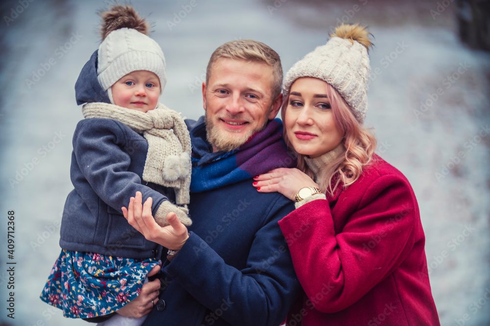 portrait of a family with a child in their arms