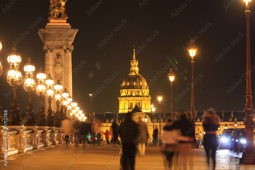 Alexander III bridge and the Invalides in Paris at night.