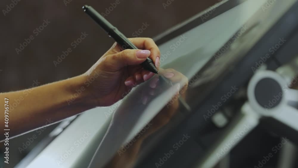 Working with interactive pen display. Drawing on a graphics tablet. The designer draws on a graphics tablet. closeup. Wallpaper production.