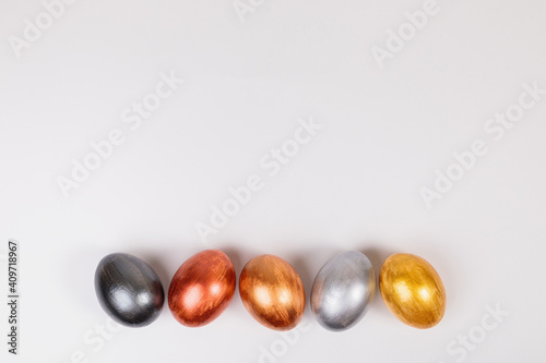 Multi-colored eggs on a uniform white background with place for text.