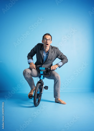 Portrait of a father riding a too small bike